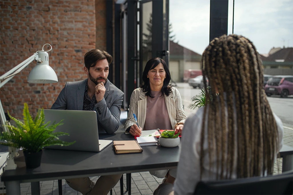 Rear view of young woman having job interview in office business and career concept